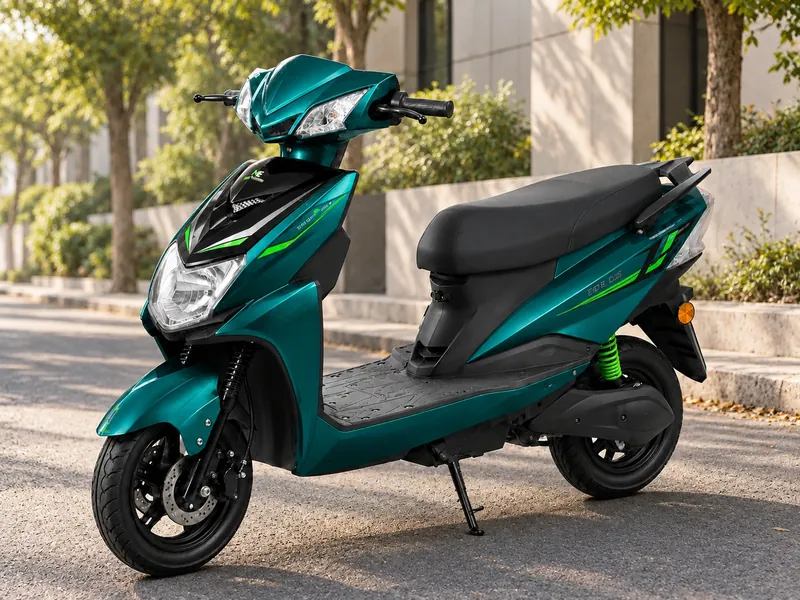 Single Light scooter in peacock green with a black front panel and green rear spring, parked on a tree-lined street